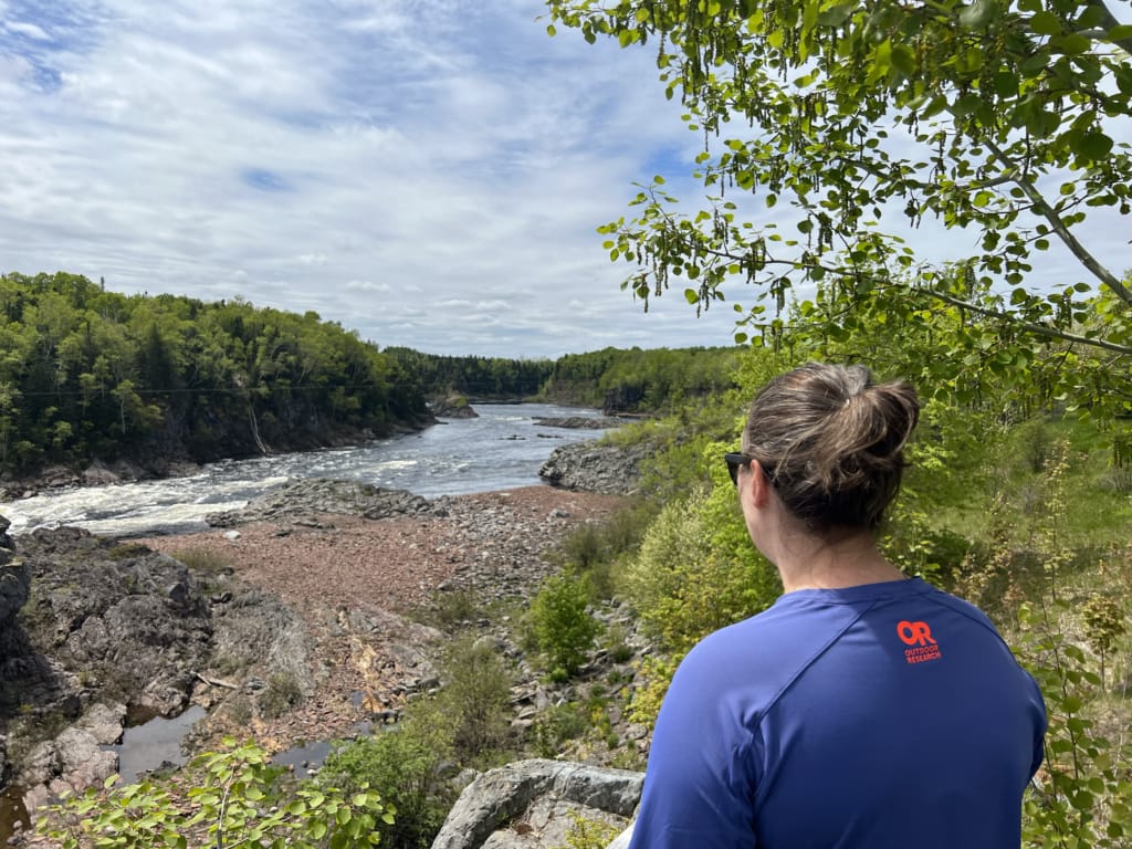 A woman looks down at the Exploits River from a viewpoint in Canyon Park in Grand Falls-Windsor