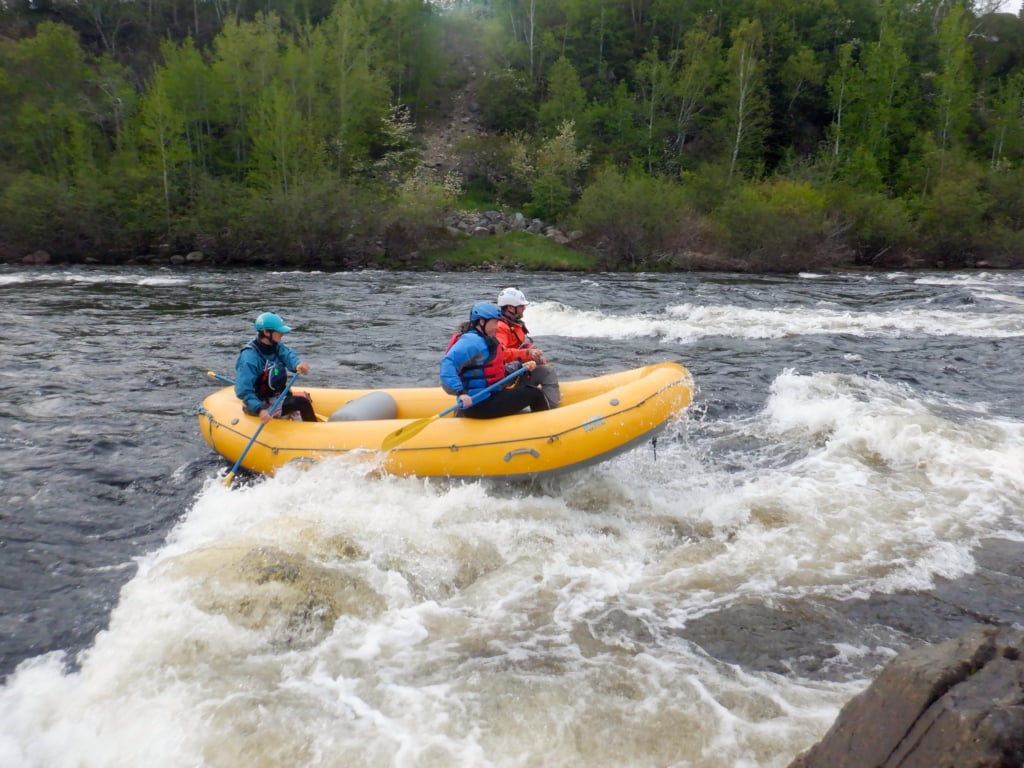Three people river rafting in Grand Falls-Windsor, NL
