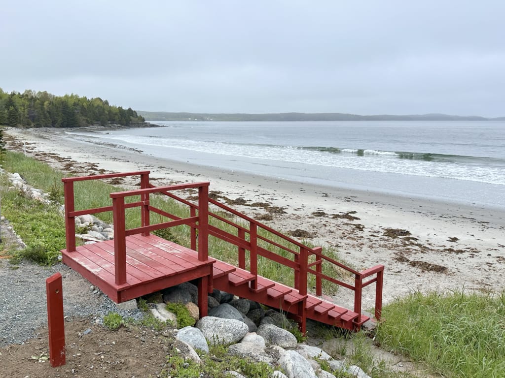 Red stairs leading down to Eastport Beach in Newfoundland