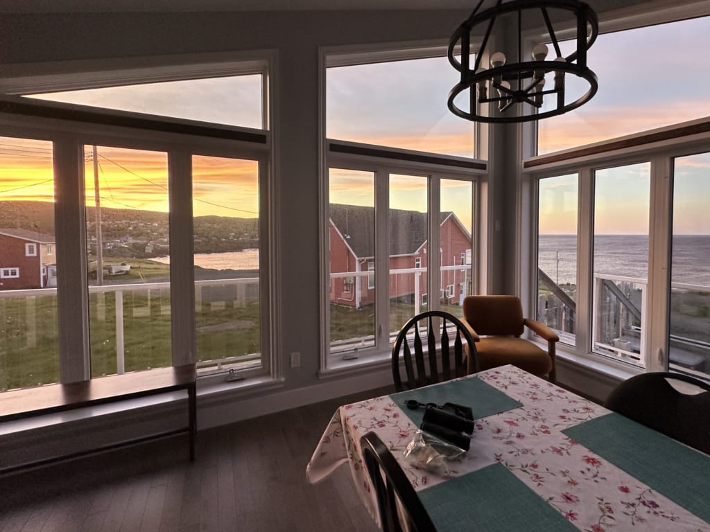 Sunset from the floor to ceiling windows at the Great Canadian Trails B&B in Pouch Cove, Newfoundland