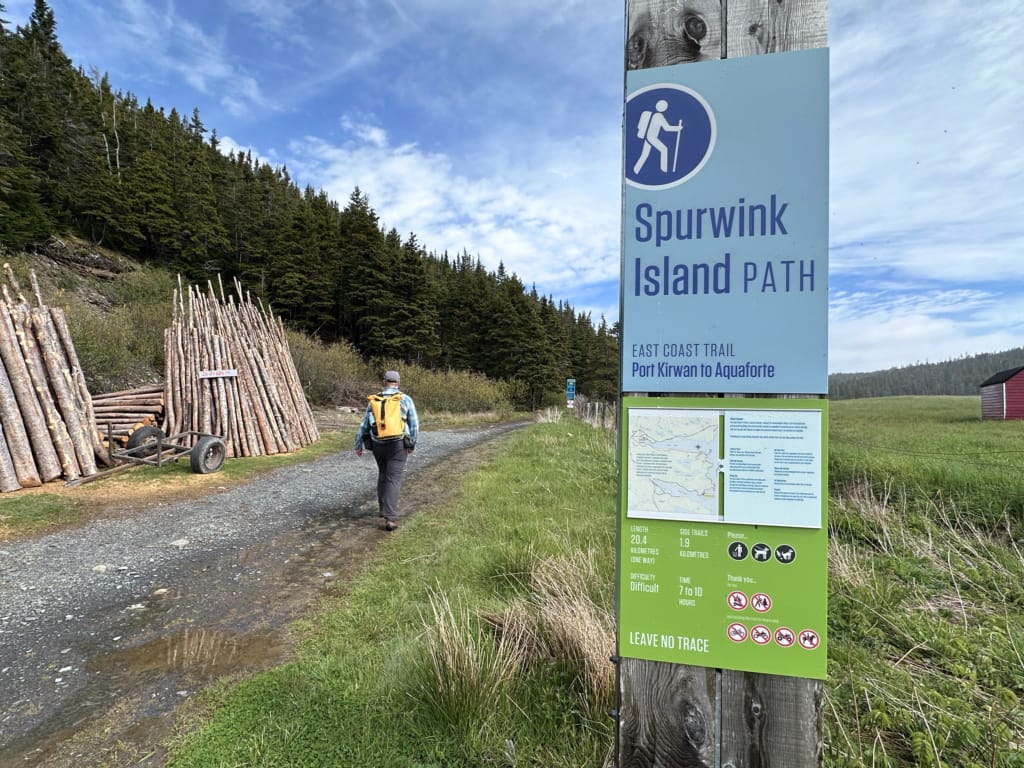 A sign with info about camping on the East Coast Trail at the trailhead for the Spurwink Island Path