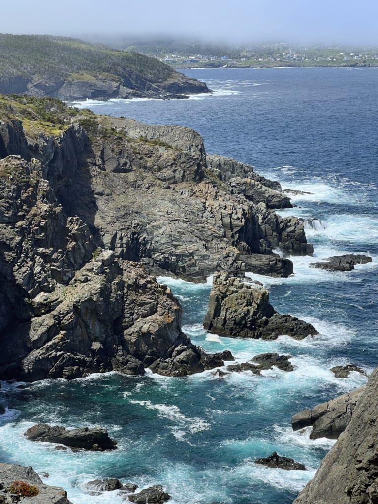 Waves crash against cliffs on the Stiles Cove Path near Pouch Cove