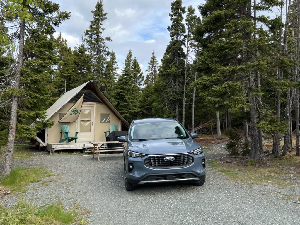 A rental car in a campsite at Terra Nova National Park in Newfoundland