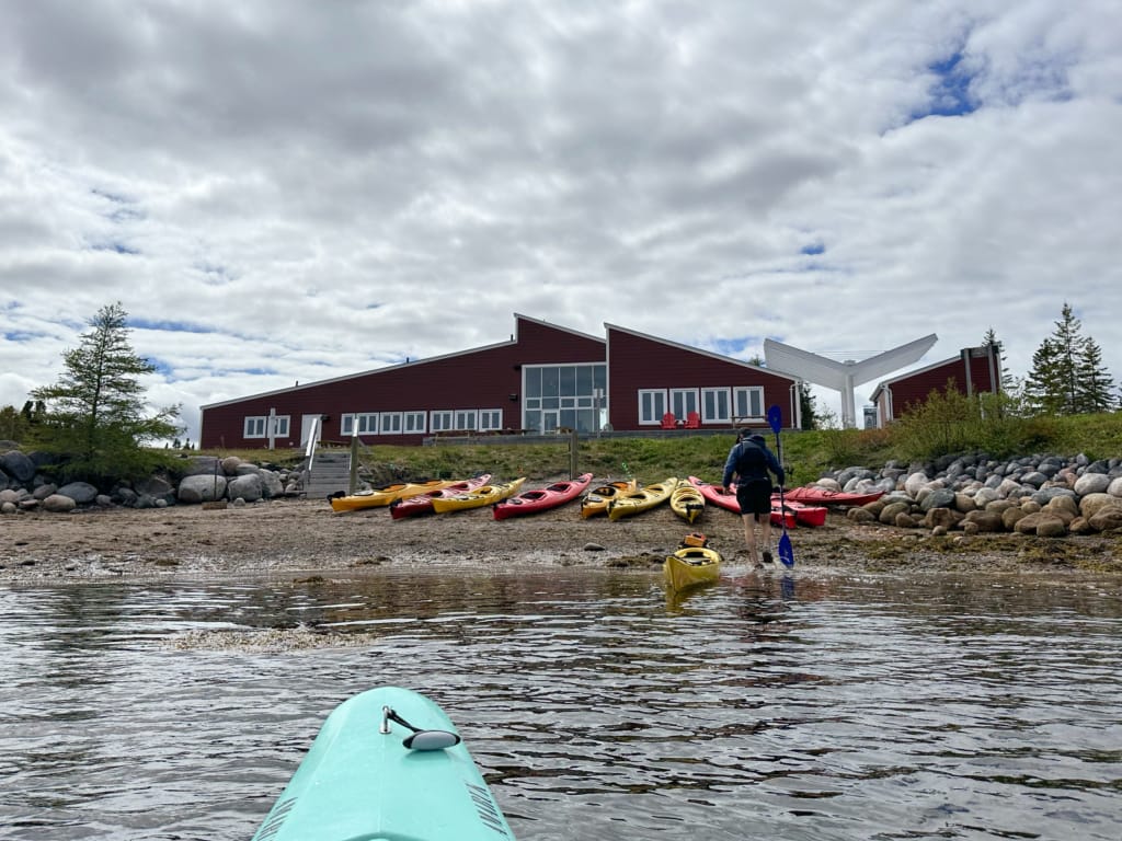 Kayaks on the beach in front of the Terra Nova National Park Visitor Centre