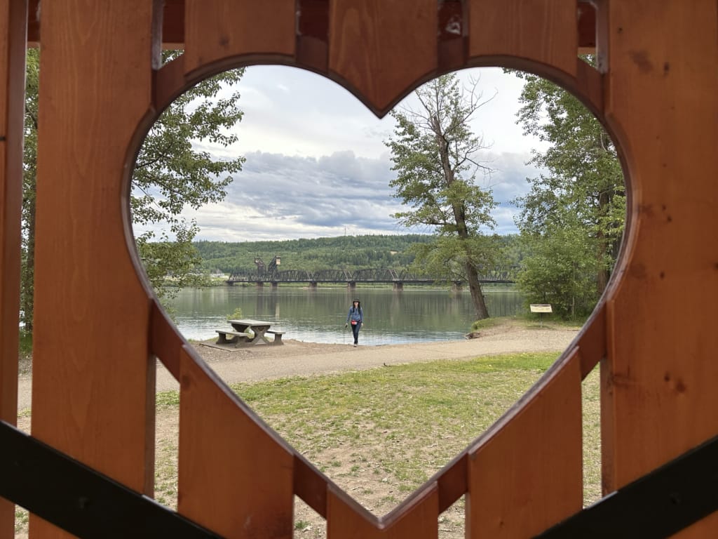 Looking through a heart shaped cut out to a view of the Fraser River in Prince George